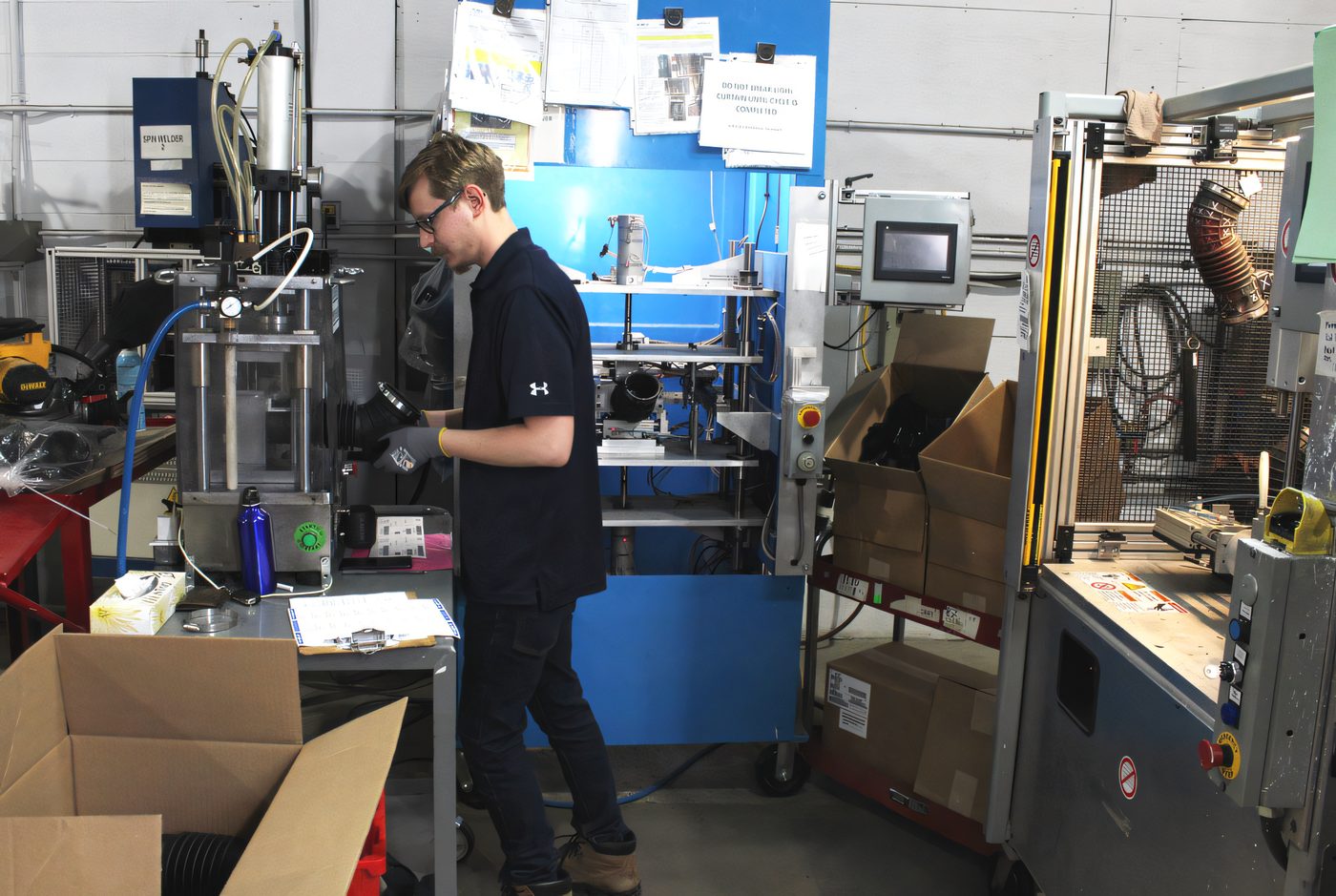 Protoplast technician working on molded components at a bench