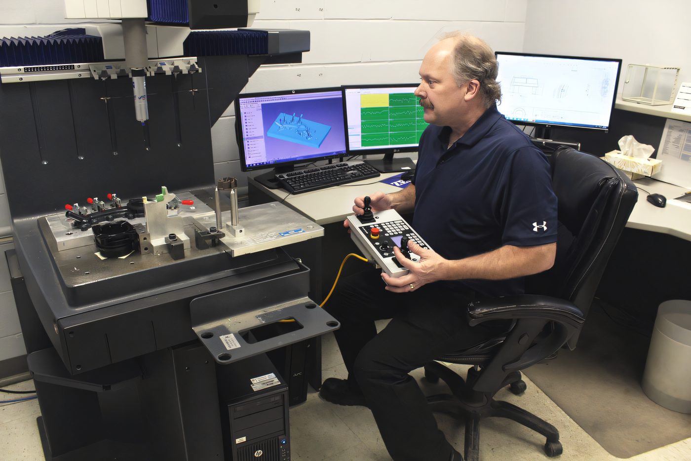 Coordinate measuring machine verifying a part in the Protoplast metrology room