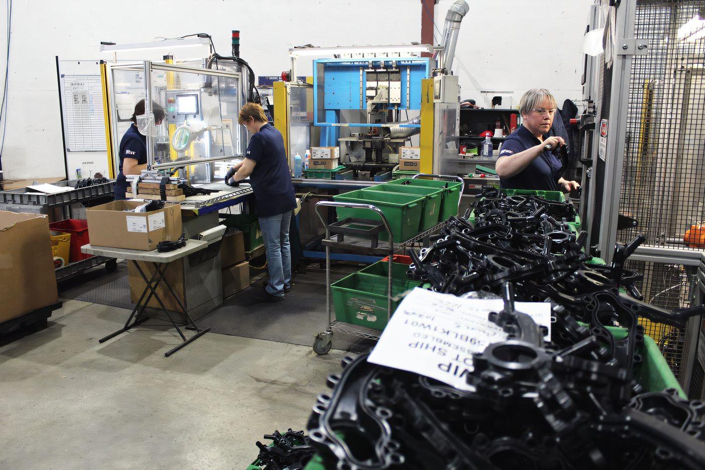 Molded black components staged in an assembly cell